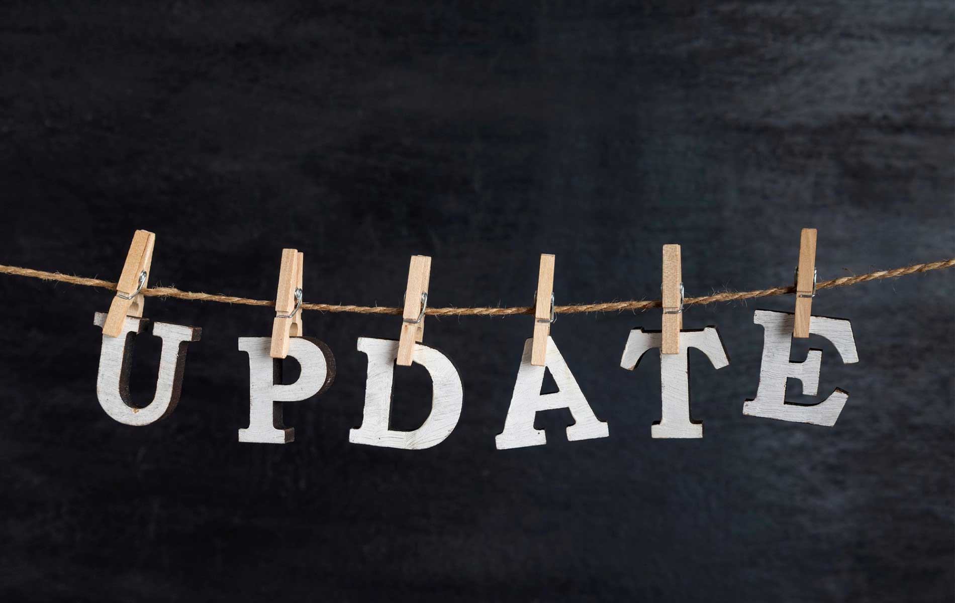 word-update-held-clothespin-rope-against-black-surface word-update-held-clothespin-rope-against-black-surface